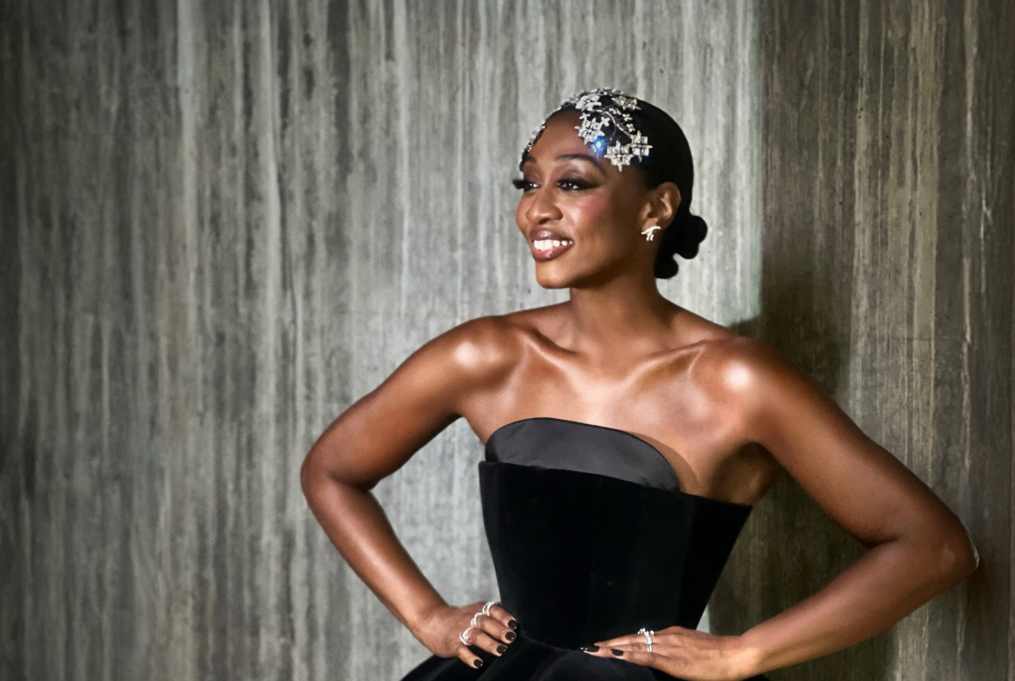 Musician Beverley Knight in black gown with hands on hips.